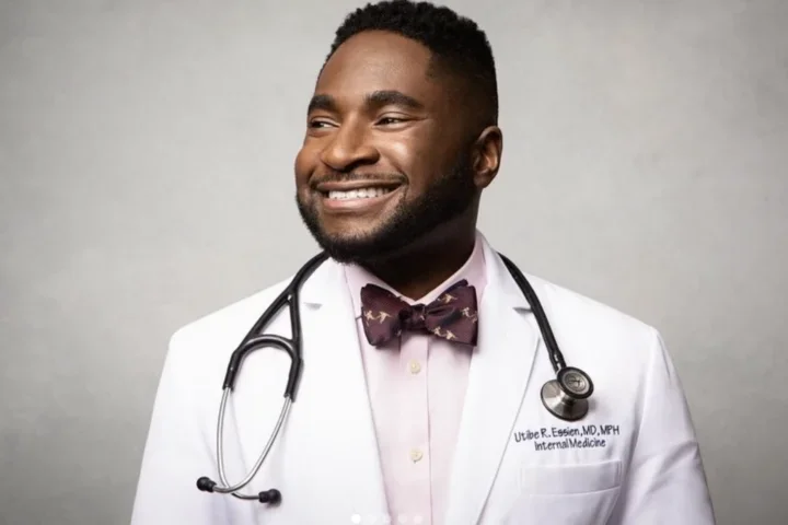 Man smiling with brown tie, stethescope, with white doctor's coat