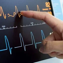 Finger pointing at heart monitor